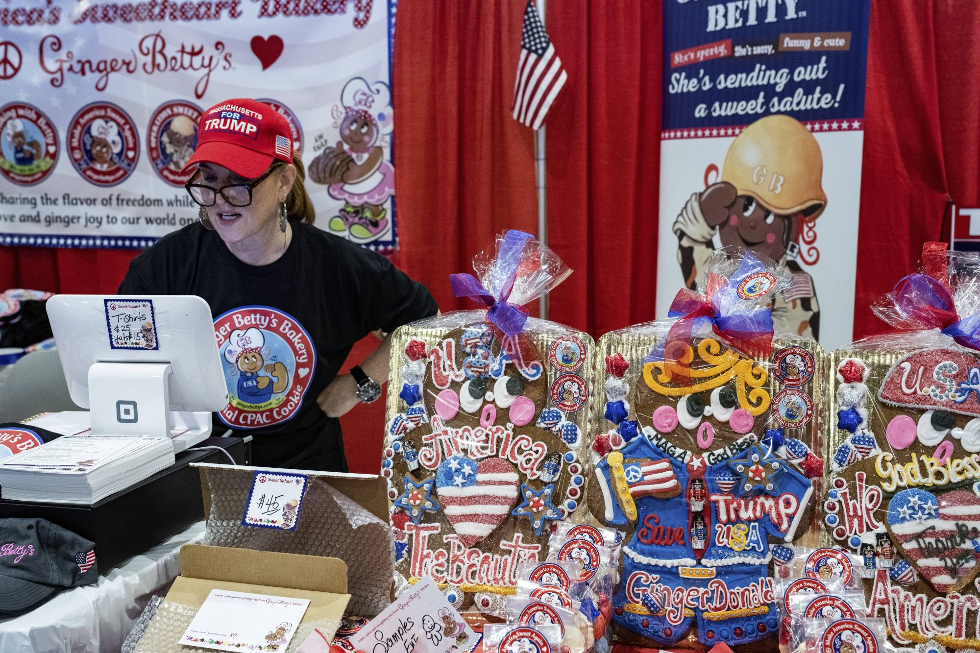 A vendor sells gingerbread cookies, including one made to look like Donald Trump, during the CPAC gathering in National Harbor, Maryland. | Haiyun Jiang / The New York Times