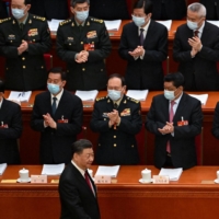 Delegates applaud as Chinese leader Xi Jinping arrives for the opening session of the National People\'s Congress in Beijing.  | AFP-JIJI