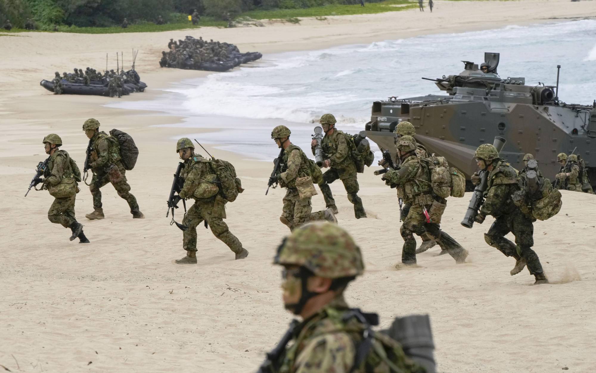 Ground Self-Defense Force members conduct a landing drill on the island of Tokunoshima in Kagoshima Prefecture on Friday as part of the Iron Fist joint exercise with the U.S. Marines. | KYODO