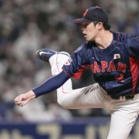 Samurai Japan\'s Roki Sasaki through a ball that hit 165 kilometers per hour, matching Shohei Ohtani\'s mark for the fastest pitch thrown by a Japanese pitcher, during a WBC warm up game against the Chunichi Dragons on Saturday. | KYODO