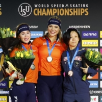 Gold medalist Jutta Leerdam (center) celebrates on the podium alongside silver medalist (left) Antoinette Rijpma-de Jong and bronze medalist Miho Takagi in Heerenveen, Netherlands, on Saturday. | REUTERS