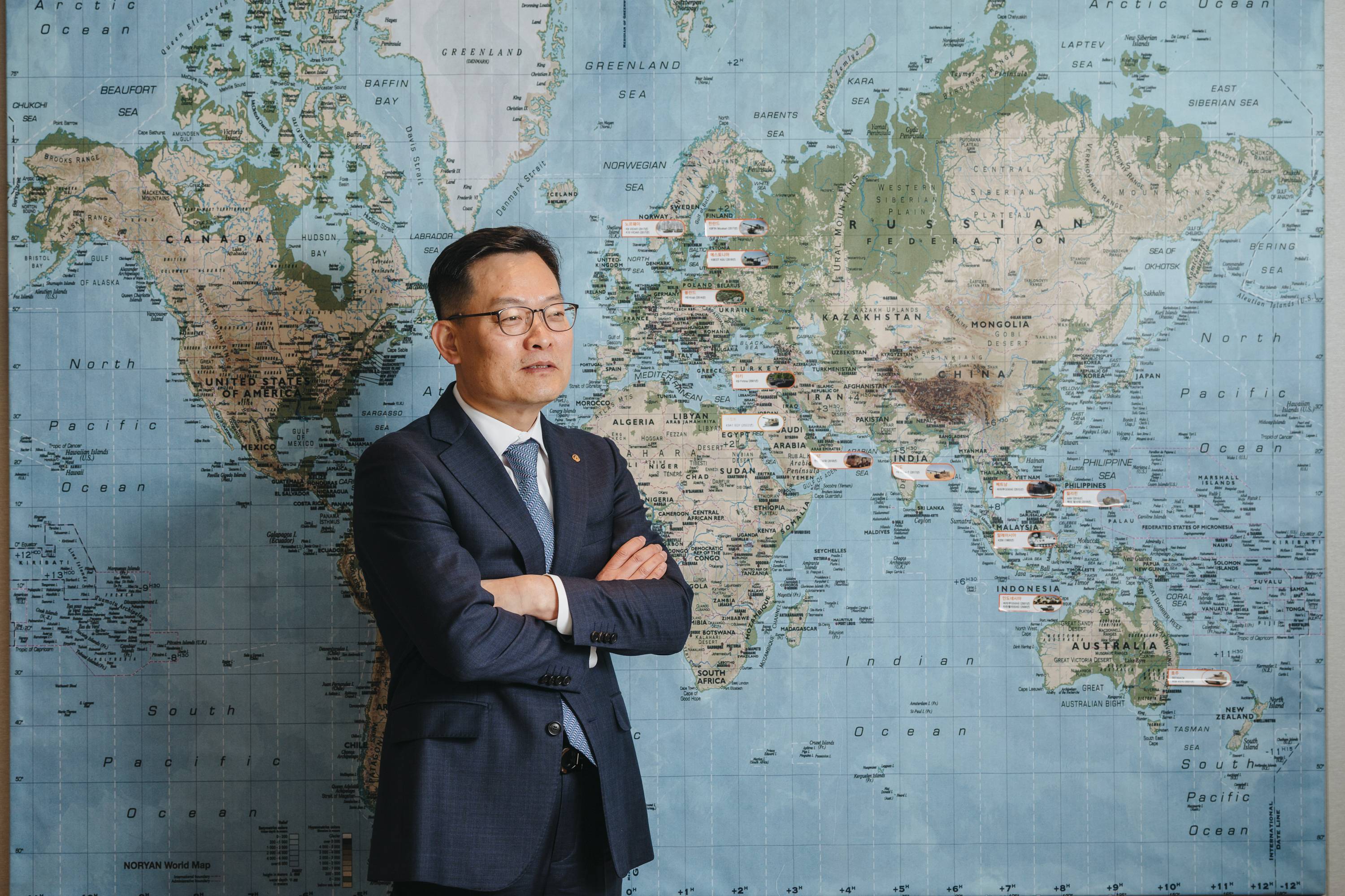 Son Jae-il, CEO of Hanwha Aerospace, at the Hanwha headquarters in Seoul. The white stickers on the map indicate the countries to which Hanwha has successfully exported arms. | Jun Michael Park / The New York Times