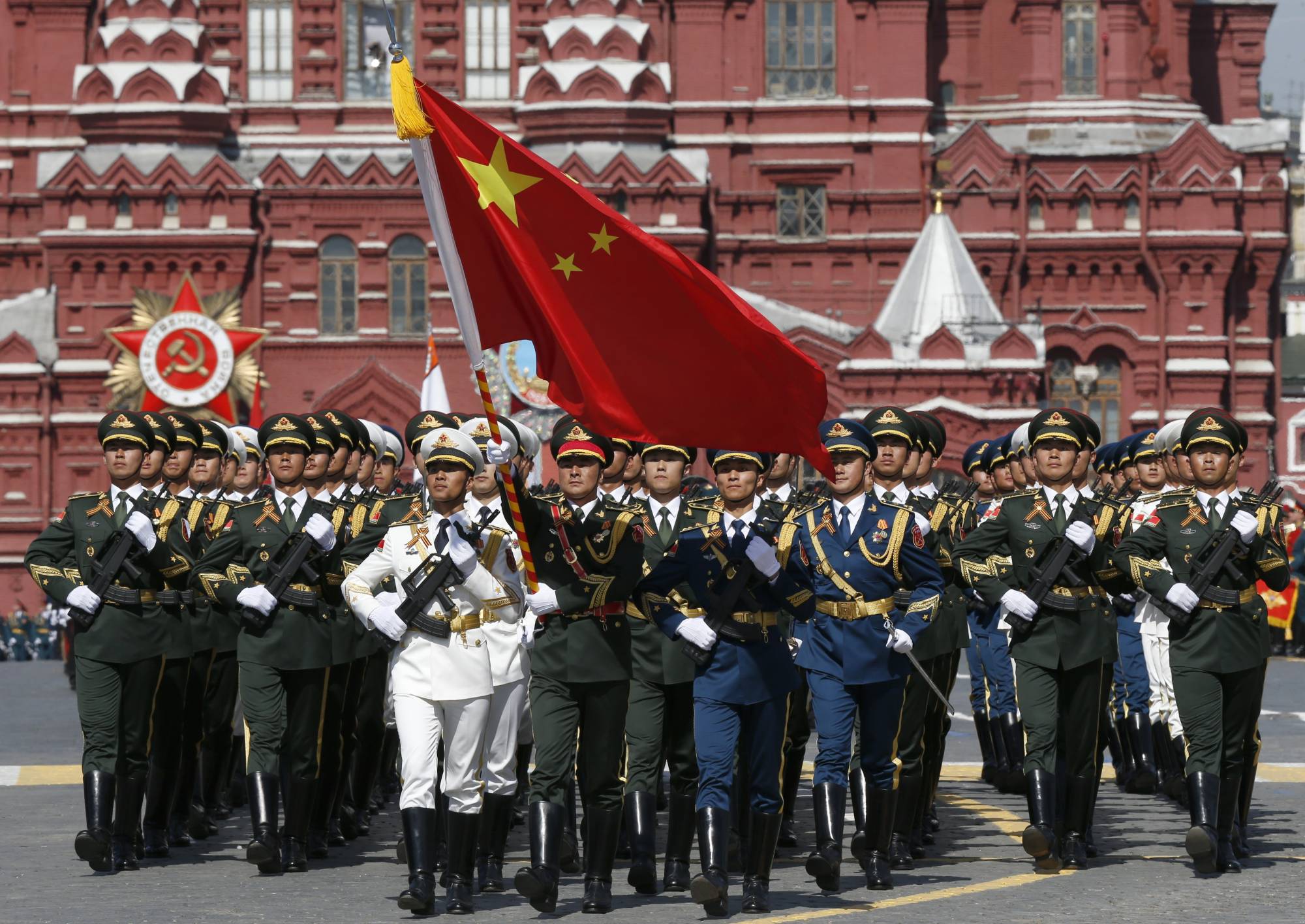 Chinese servicemen march in Russia’s Victory Day parade in Moscow in May 2015. China’s trade with Russia rose by 34.3% in 2022, and it soaked up its neighbor’s boycotted-energy exports.   | REUTERS