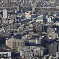 Tokyo reported 989 new cases of COVID-19 on Tuesday. | BLOOMBERG