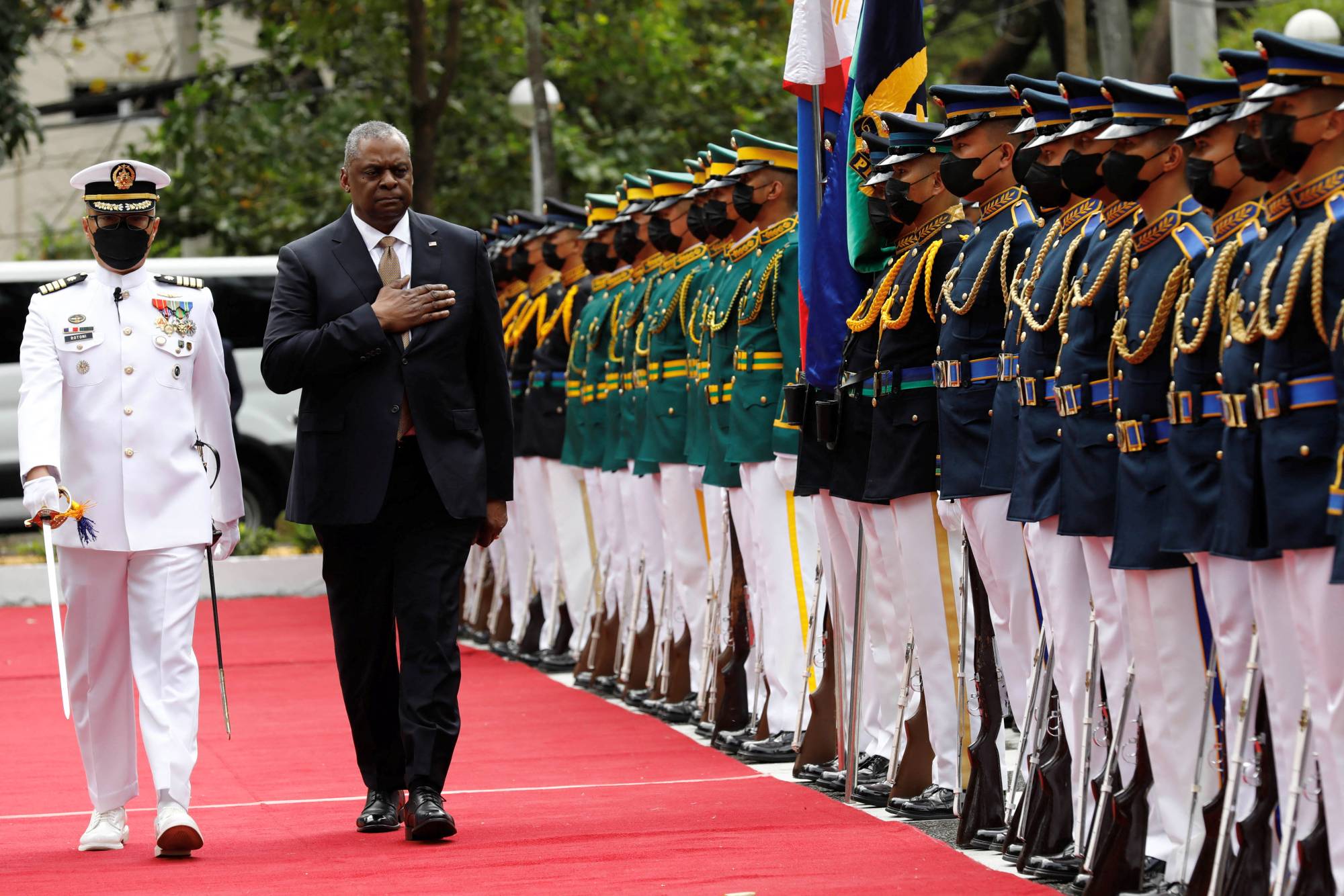 U.S. Defense Secretary Lloyd Austin is honored with a military guard at a base in Quezon City, Philippines, on Feb. 2. Until recently, security cooperation between Japan, the Philippines and the U.S. was barely a consideration. | POOL / VIA REUTERS