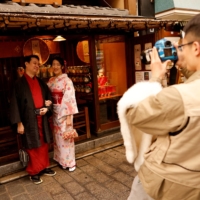 Tourists from Taiwan pose for a photograph in Tokyo\'s Asakusa district in January. | REUTERS
