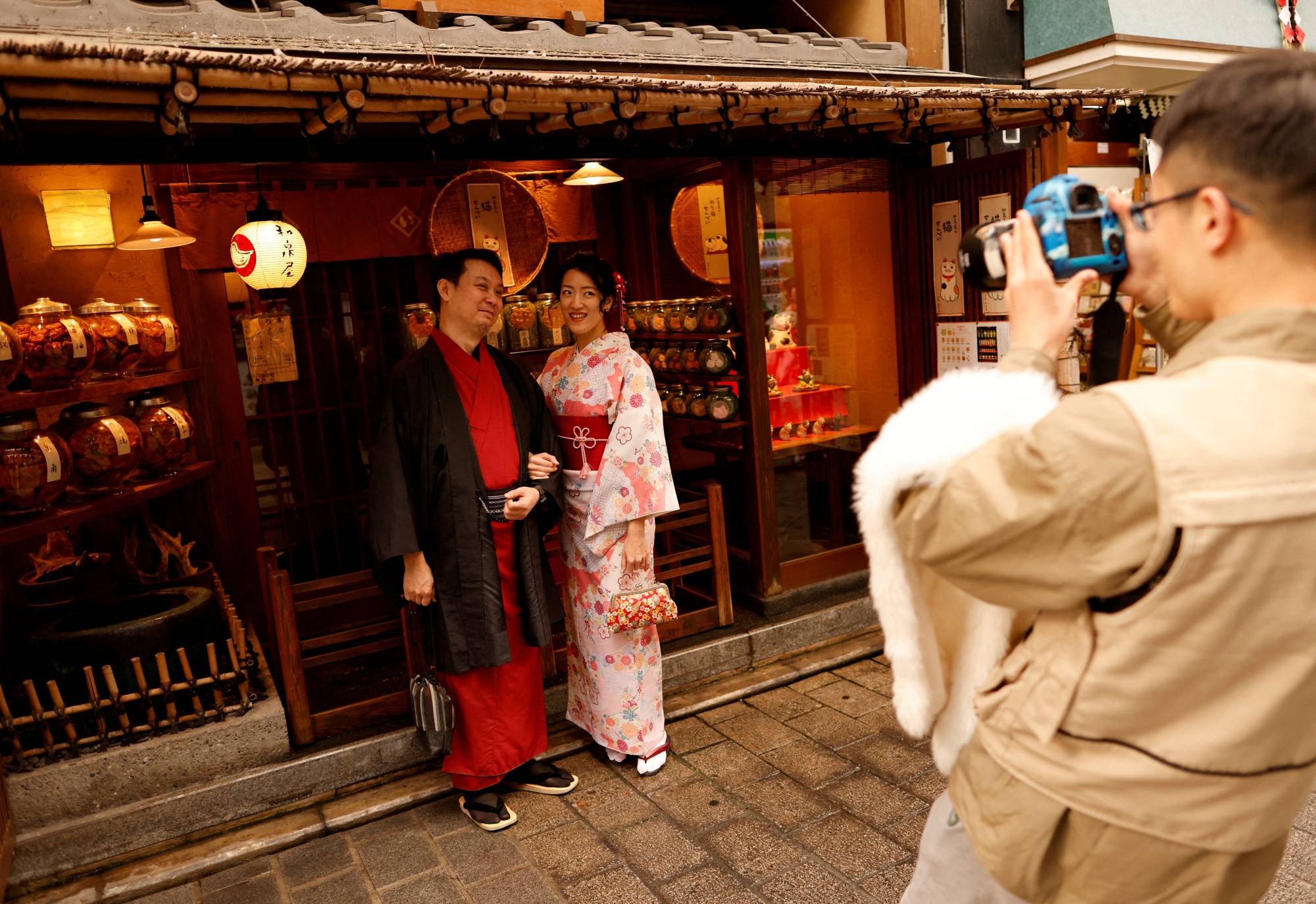 Tourists from Taiwan pose for a photograph in Tokyo's Asakusa district in January. | REUTERS