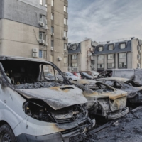 Damaged vehicles where missile parts fell onto a residential parking lot and destroyed several cars in the Sviatoshynskyi district of Kyiv on Thursday | LAETITIA VANCON / THE NEW YORK TIMES