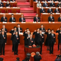 Newly-elected vice chairpersons and secretary general of the National People\'s Congress take an oath led by Li Hongzhong (front) after being elected during the third plenary session of the National People\'s Congress at the Great Hall of the People in Beijing on Friday | AFP-JIJI