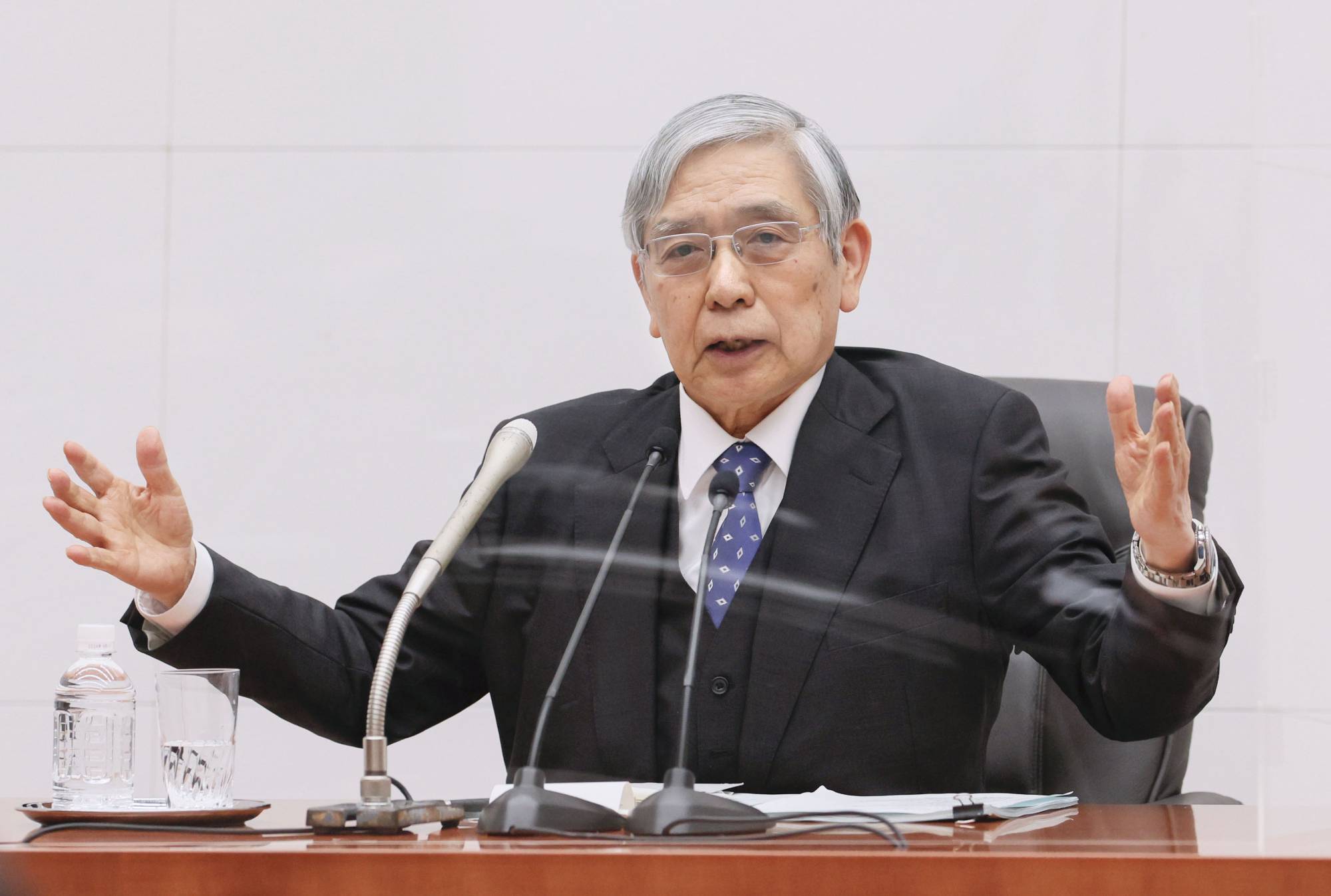 Bank of Japan Gov. Haruhiko Kuroda speaks during a news conference at the central bank's headquarters in Tokyo on Friday. | POOL / VIA KYODO 