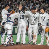 Japan\'s players celebrate their victory against the Czech Republic in Pool B of the World Baseball Classic at Tokyo Dome on Saturday. | AFP-JIJI