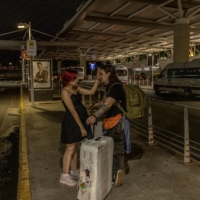 Maria Konovalova greets her husband, Yuriy, who flew in from Russia, at the airport in Buenos Aires. | SARAH PABST / THE NEW YORK TIMES