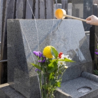 After offerings are made and prayers are said, Japanese family members will pour water over the gravestone in an act of purification. | GETTY IMAGES