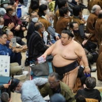 Takakeisho leaves the ring after defeating Tamawashi on Day 2 of the Spring Grand Sumo Tournament in Osaka on Monday. | KYODO