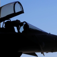 This photo taken in September 2016 shows a Royal Air Force military mechanic checking a Eurofighter Typhoon fighter jet before it takes off from RAF\'s Akrotiri base in Cyprus. | GETTY IMAGES / VIA BLOOMBERG