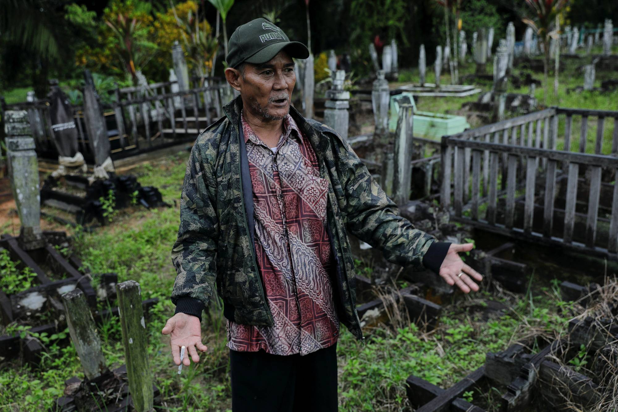 Indigenous Balik tribe leader Sibukdin, 60, visits his tribe's cemetery complex at their village, located near Indonesia's projected new capital | Reuters 