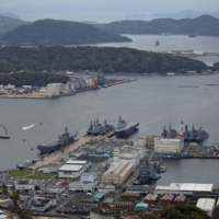 Maritime Self-Defense Force vessels moored at the Sasebo naval base in April 2018. Sasebo is among the military facilities expected to be at even greater risk from storm surges, flooding and coastal erosion. | REUTERS