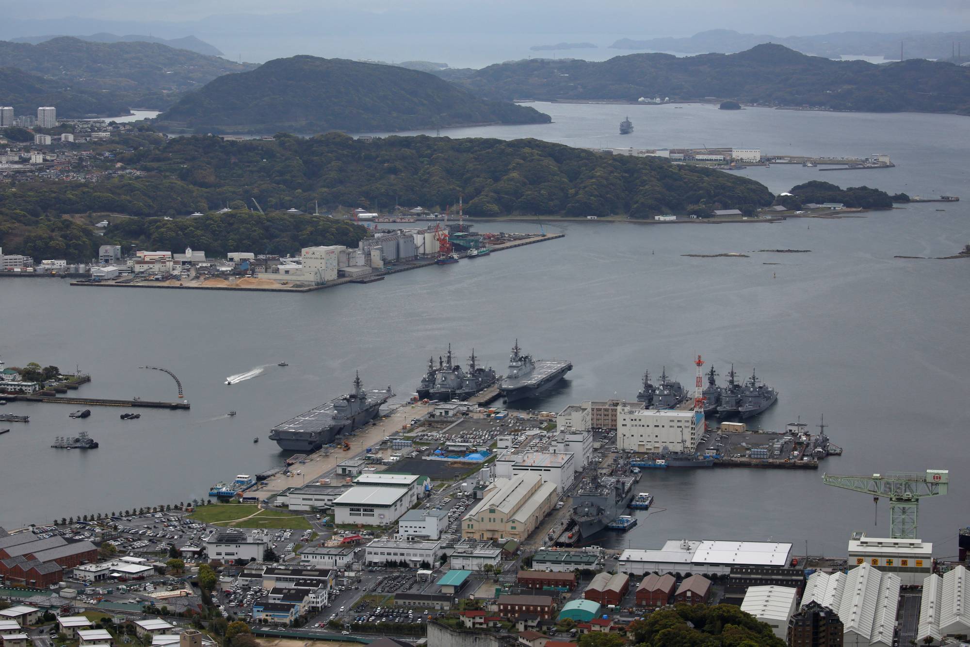 Maritime Self-Defense Force vessels moored at the Sasebo naval base in April 2018. Sasebo is among the military facilities expected to be at even greater risk from storm surges, flooding and coastal erosion. | REUTERS