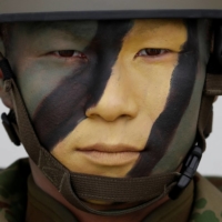 A soldier of the GSDF\'s Amphibious Rapid Deployment Brigade at the GSDF\'s Camp Ainoura in Sasebo, Nagasaki Prefecture, in April 2018. SDF and U.S. personnel could face increased health risks due to heat waves or extremely high temperatures exacerbated by climate change. | REUTERS