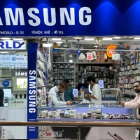 People shop inside a store selling Samsung mobile phones and accessories in Mumbai, India, in March. | REUTERS