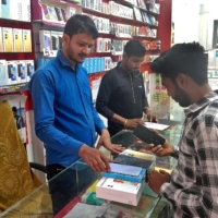 A customer checks a Samsung mobile phone before purchasing it, in a store in Lucknow, India, in March. | REUTERS