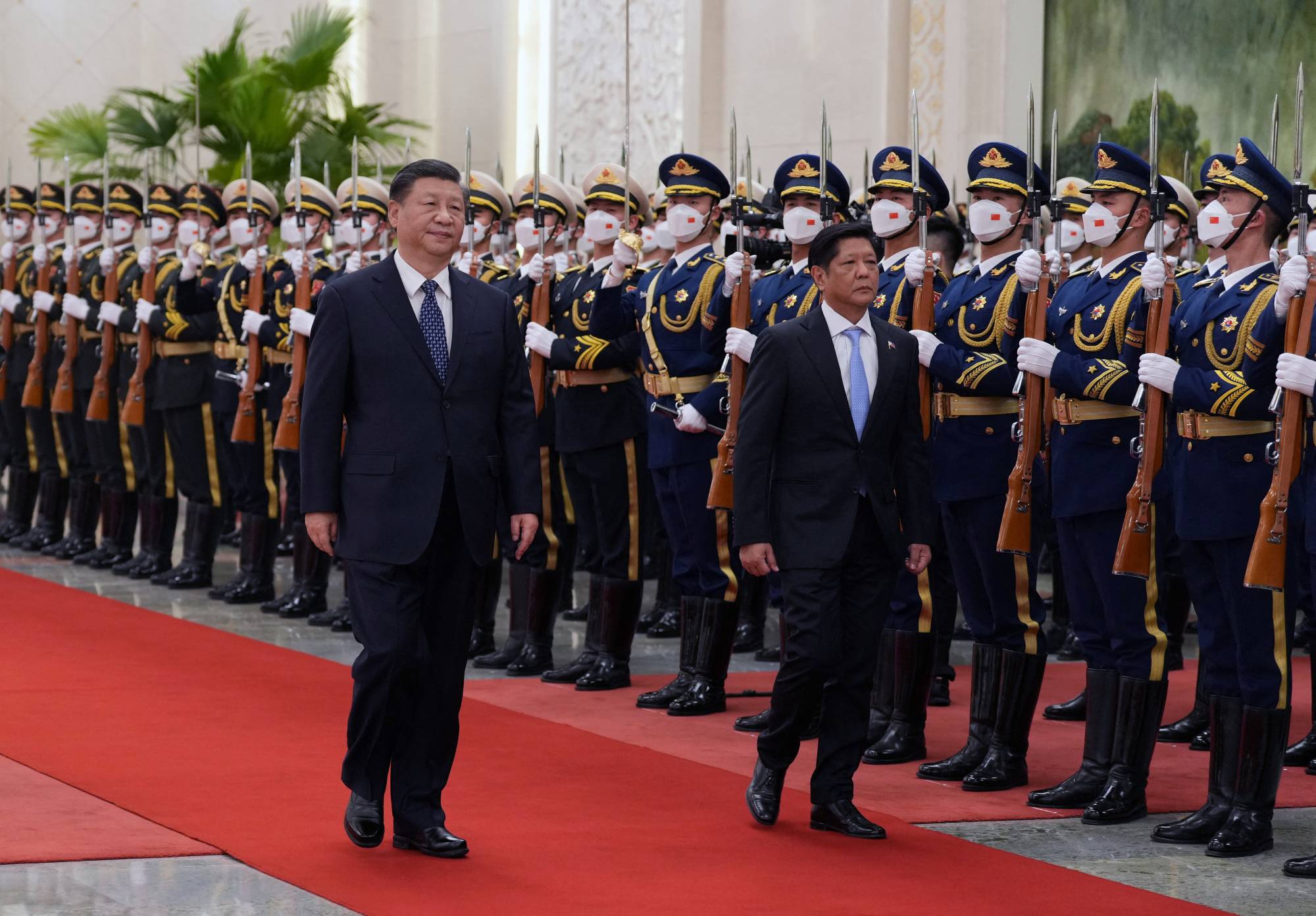 Chinese President Xi Jinping and his Philippine counterpart, Ferdinand Marcos Jr., review an honor guard during a welcome ceremony at the Great Hall of the People in Beijing in January. | CNSPHOTO / VIA REUTERS 