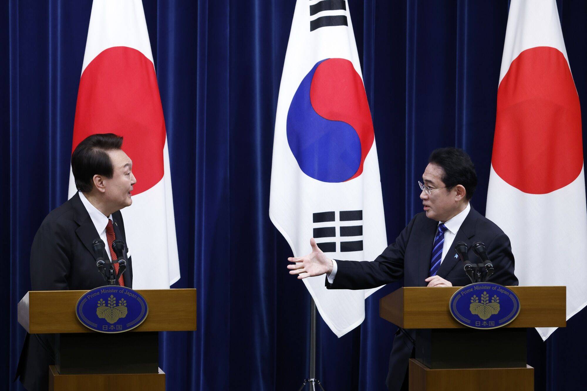 Prime Minster Fumio Kishida and South Korean President Yoon Suk-yeol give a joint news conference during summit talks in Tokyo on Thursday.  | BLOOMBERG