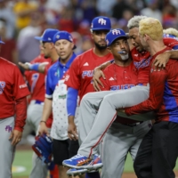 Puerto Rico pitcher Edwin Diaz is carried off the field after injuring his leg following his team\'s win over the Dominican Republic at the World Baseball Classic in Miami on Wednesday. | USA TODAY / VIA REUTERS