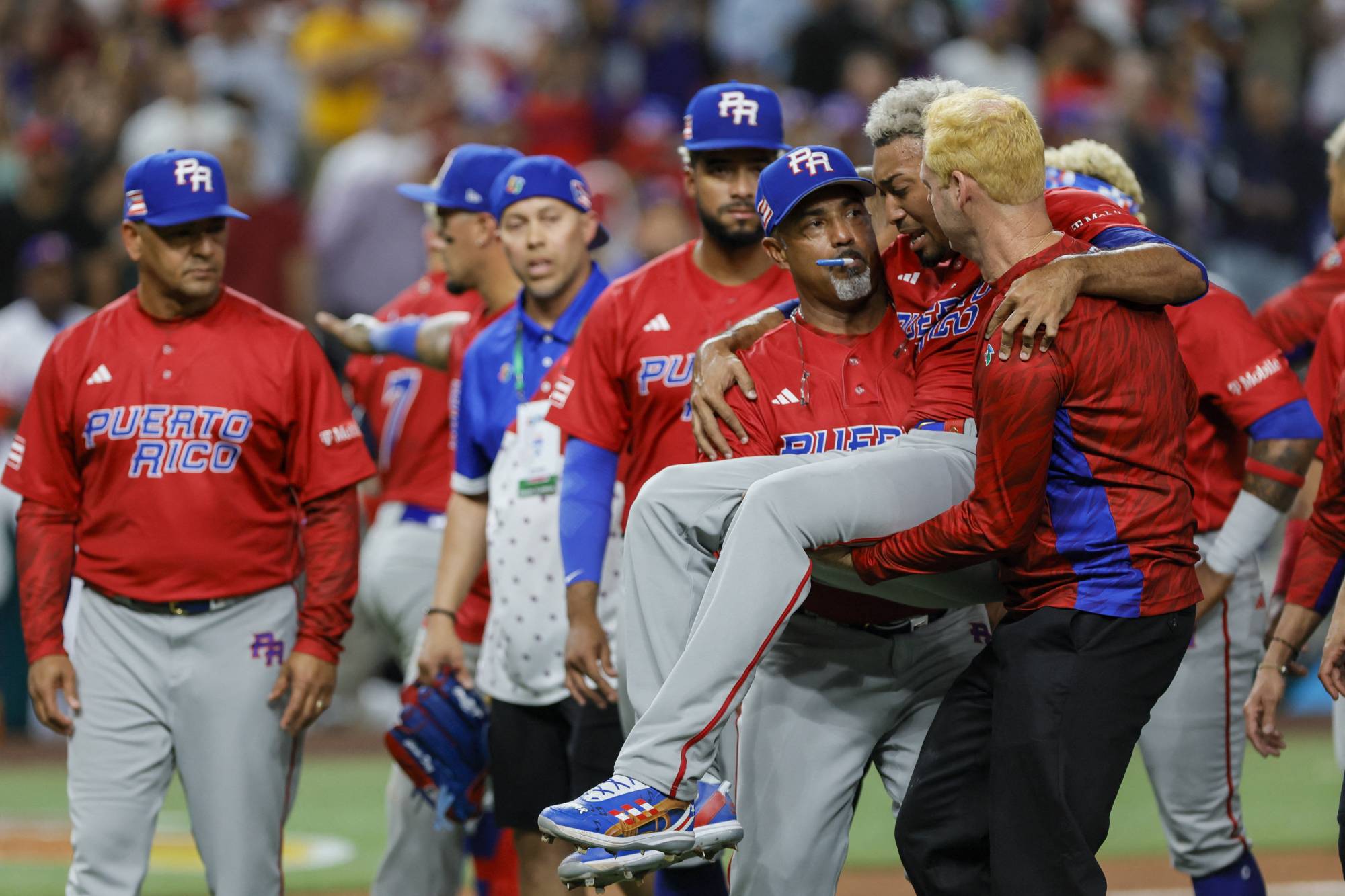 Puerto Rico pitcher Edwin Diaz is carried off the field after injuring his leg following his team's win over the Dominican Republic at the World Baseball Classic in Miami on Wednesday. | USA TODAY / VIA REUTERS