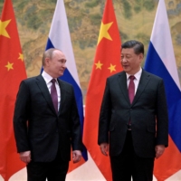 Russian President Vladimir Putin (left) attends a meeting with Chinese President Xi Jinping in Beijing in February 2022. | KREMLIN / SPUTNIK/ VIA REUTERS 