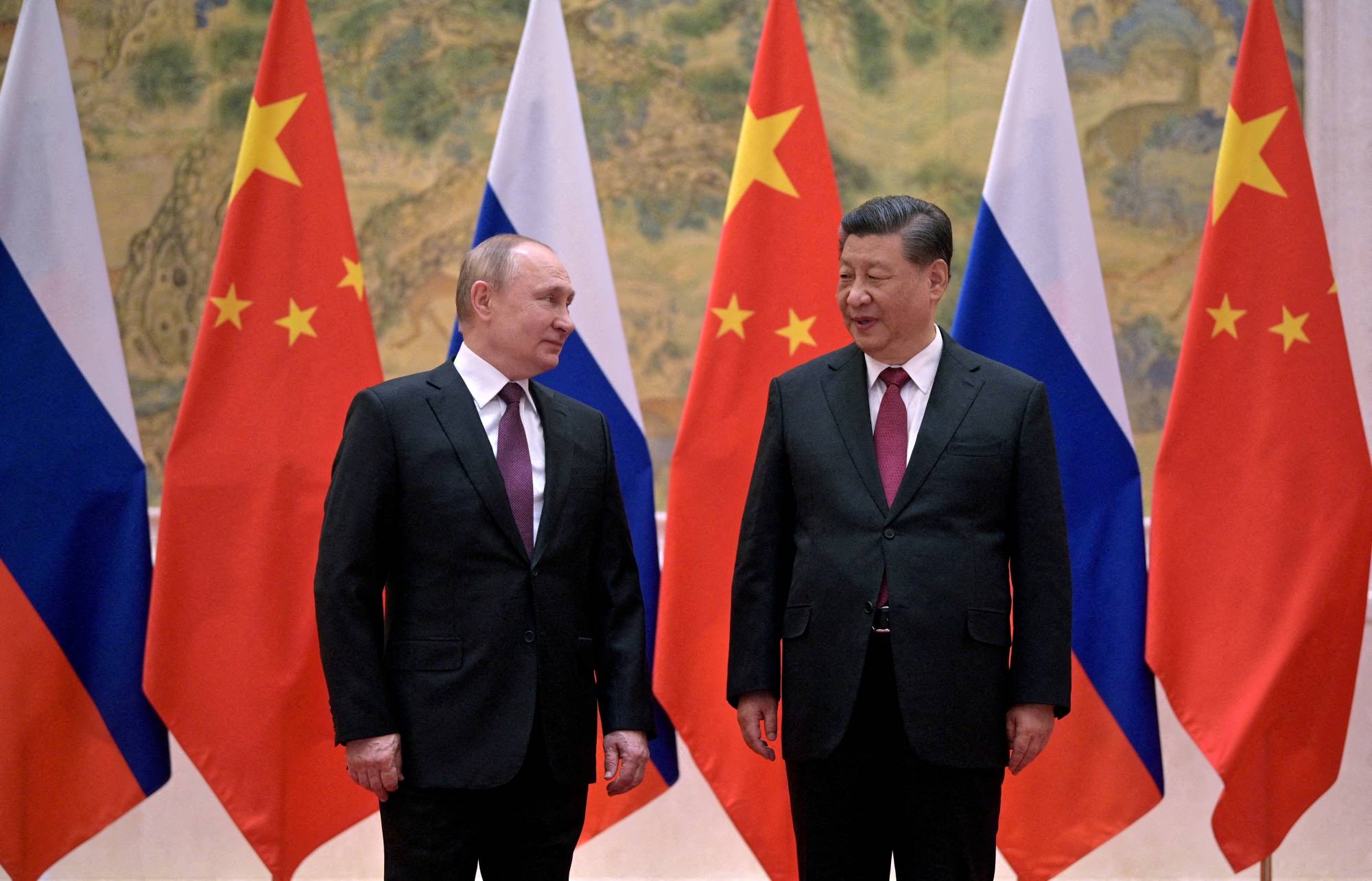 Russian President Vladimir Putin (left) attends a meeting with Chinese President Xi Jinping in Beijing in February 2022. | KREMLIN / SPUTNIK/ VIA REUTERS 