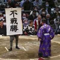 A banner announcing Nishikigi\'s win over Takakeisho after the lone ozeki withdrew, at Edion Arena Osaka on Saturday.  | KYODO 