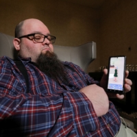 Andrew McCarroll holds his smartphone while corresponding with his Replika AI chatbot, in Billings, Montana, on March 12. | REUTERS