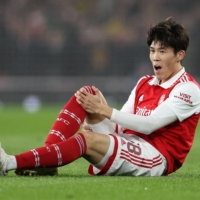 Arsenal defender Takehiro Tomiyasu suffers an injury during his team\'s Europa League round-of-16 match against Sporting Lisbon in London on Thursday. | REUTERS