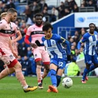 Brighton\'s Kaoru Mitoma takes a shot against Grimsby Town in the FA Cup quarterfinals in Brighton, England, on Sunday.  | AFP-JIJI