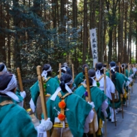Agon Shu faithful dressed in <i>yamabushi</i> (mountain priest) costumes ascend from the adjoining hills into the amphitheater’s central enclosure