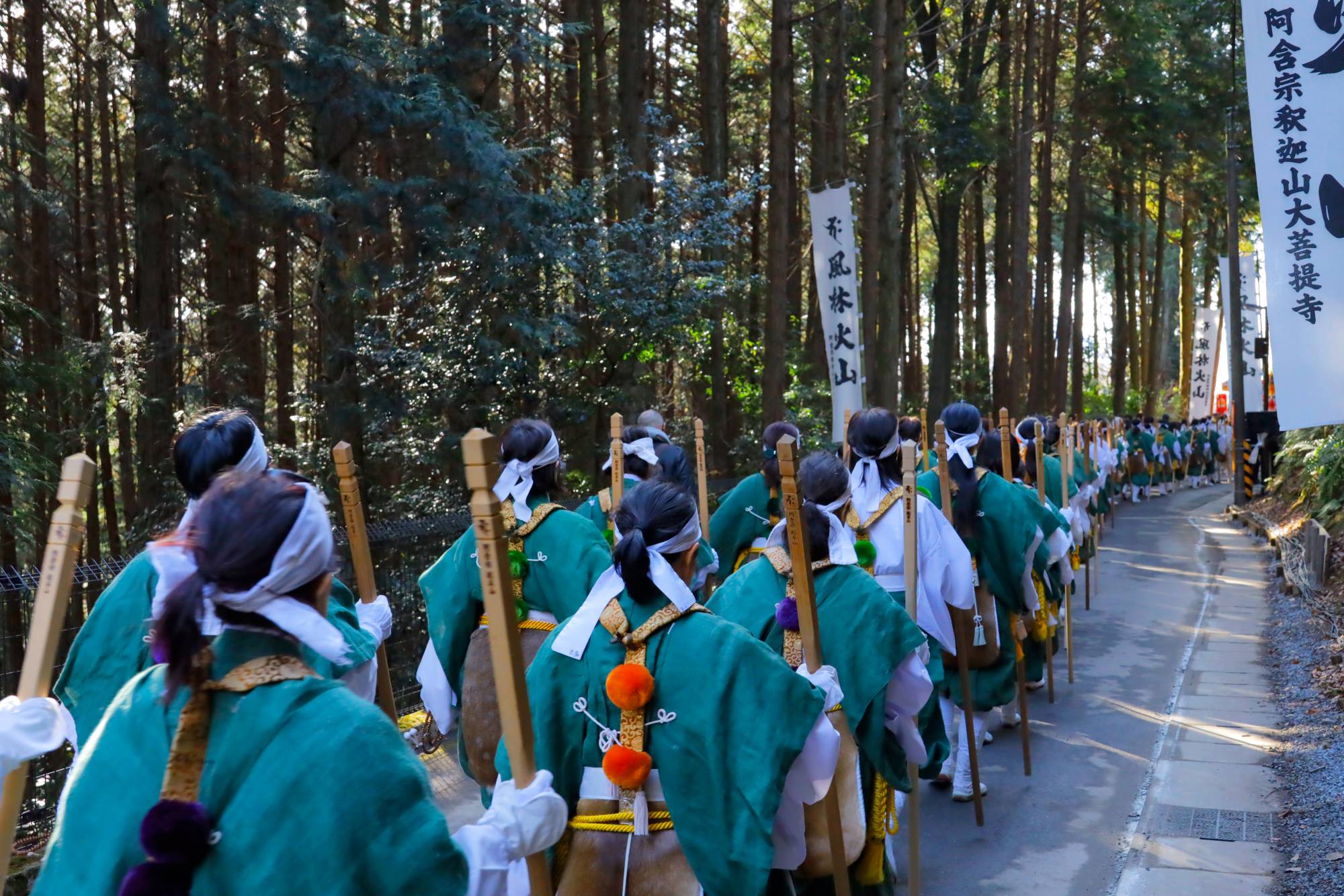 Agon Shu faithful dressed in <i>yamabushi</i> (mountain priest) costumes ascend from the adjoining hills into the amphitheater’s central enclosure
