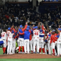 Members of Cuba\'s team celebrate their 4-3 victory in the World Baseball Classic game against Australia in Tokyo on March 15. | AFP-JIJI