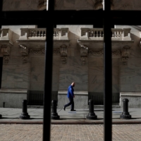 A trader wearing a protective face mask at the New York Stock Exchange in the financial district of New York | REUTERS