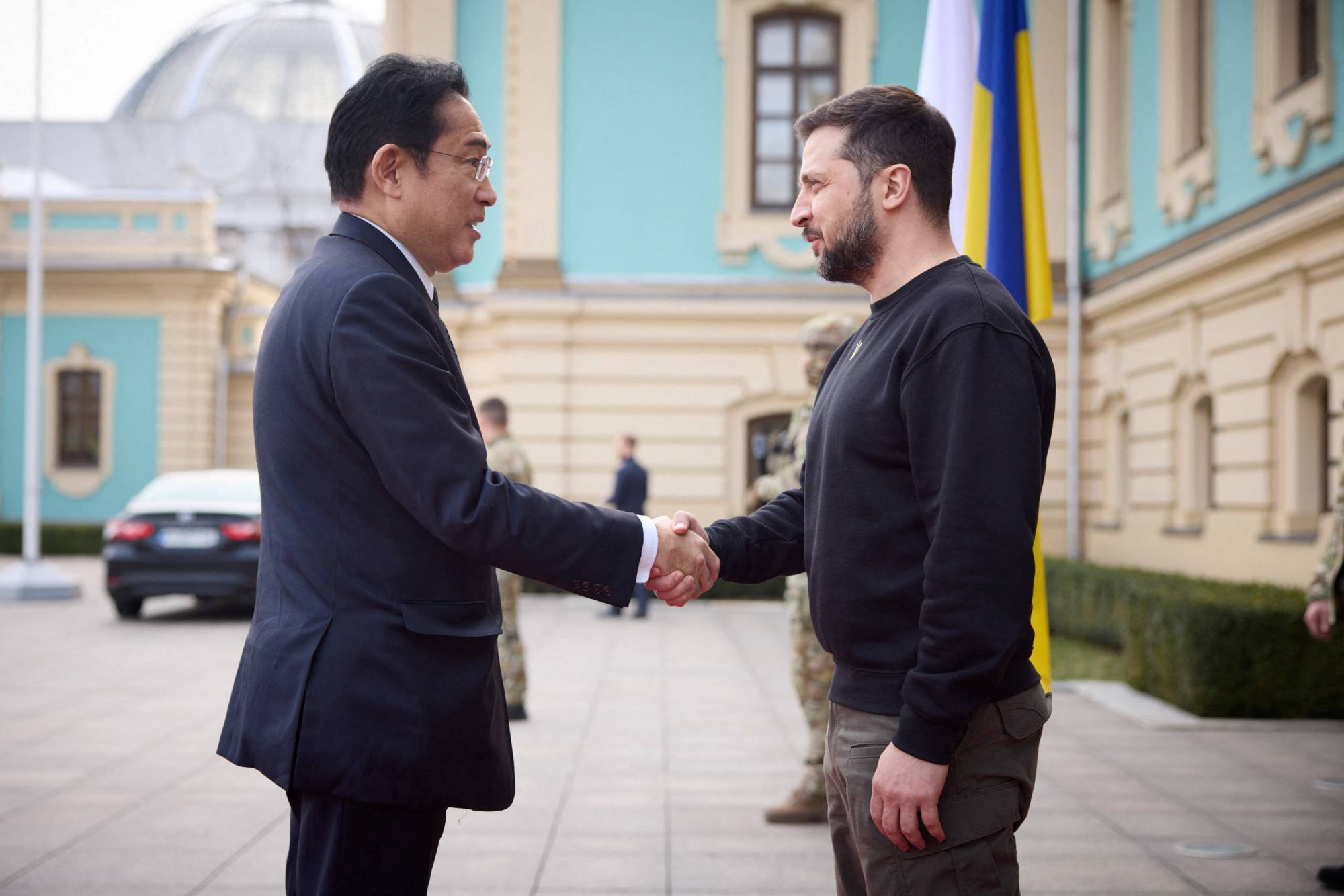 Prime Minister Fumio Kishida shake hands with Ukrainian President Volodymyr Zelenskyy as they meet in Kyiv on Tuesday.  | UKRAINIAN PRESIDENTIAL PRESS SERVICE / VIA REUTERS