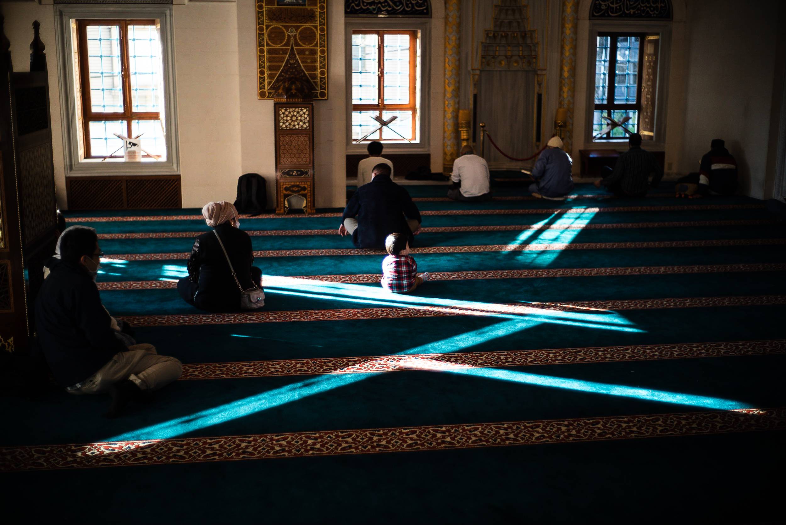 A boy sits in the prayer space of Tokyo Camii, a mosque in Shibuya Ward. | JOHAN BROOKS