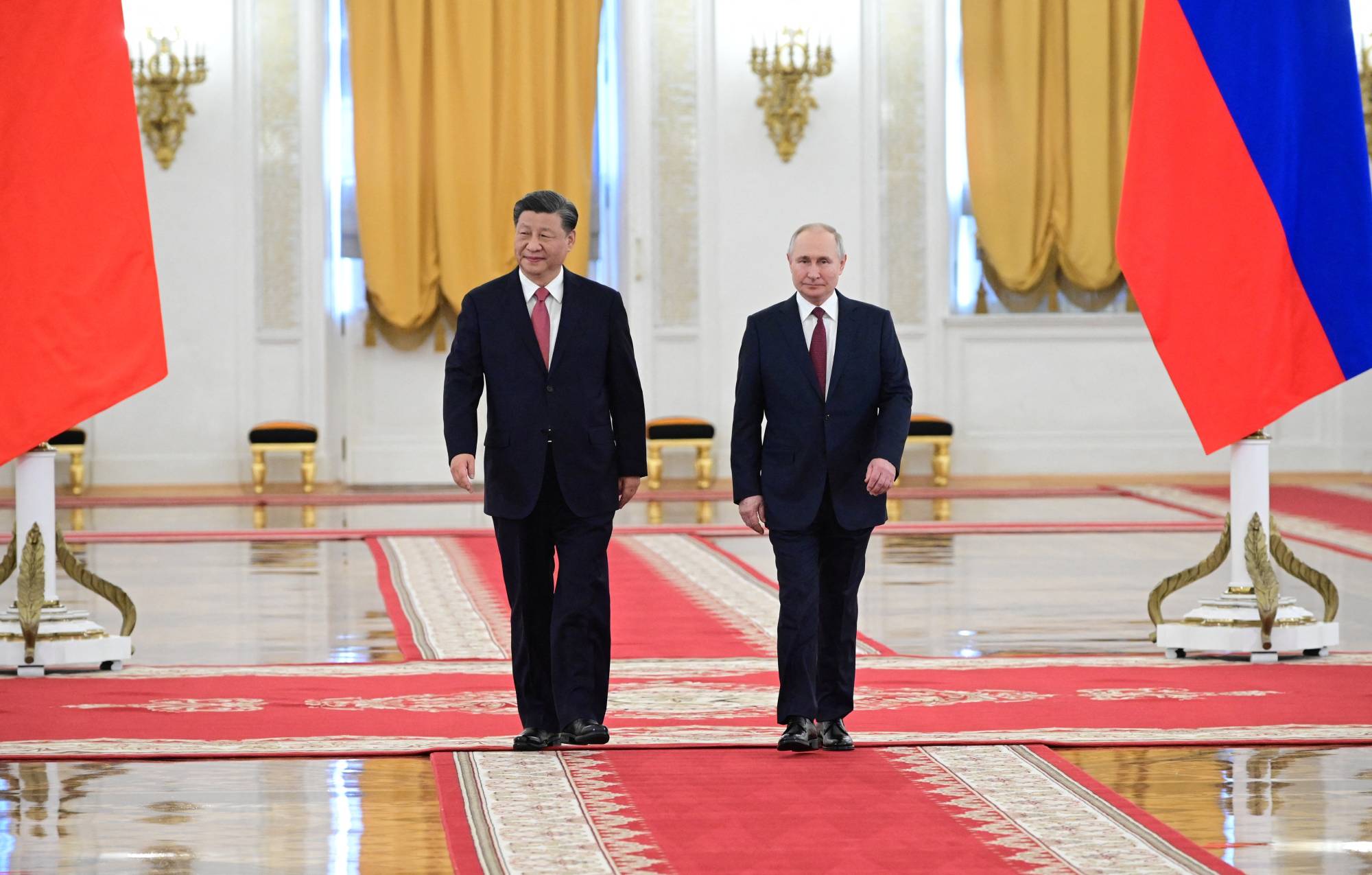 Russian President Vladimir Putin and his Chinese counterpart, Xi Jinping, attend a welcome ceremony ahead of their talks at the Kremlin in Moscow on Tuesday. | SPUTNIK / KREMLIN / VIA REUTERS  