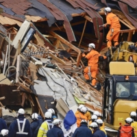 Rescuers search for missing people after a landslide in Tsuruoka, Yamagata Prefecture, on Dec. 31. | KYODO
