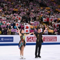 Japanese ice dancers Kana Muramoto (left) and Daisuke Takahashi react after their performance in the rhythm dance competition during the ISU World Figure Skating Championships in Saitama on Friday. | AFP-JIJI