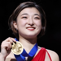 Kaori Sakamoto poses with her gold medal after winning the women\'s singles competition at the 2023 ISU World Figure Skating Championships in Saitama on Friday. | REUTERS