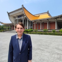 William Stanton, former director of the American Institute in Taiwan (AIT), the de facto U.S. embassy in Taiwan, stands in front of the Sun Yat-Sen Memorial Hall in Taipei during an interview earlier this month.  | GABRIEL DOMINGUEZ