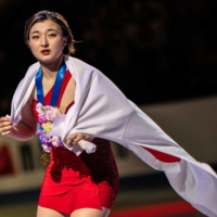 Kaori Sakamoto takes a celebratory lap around the ice after winning the women\'s singles gold medal at the ISU World Figure Skating Championships in Saitama on Friday. | AFP-JIJI