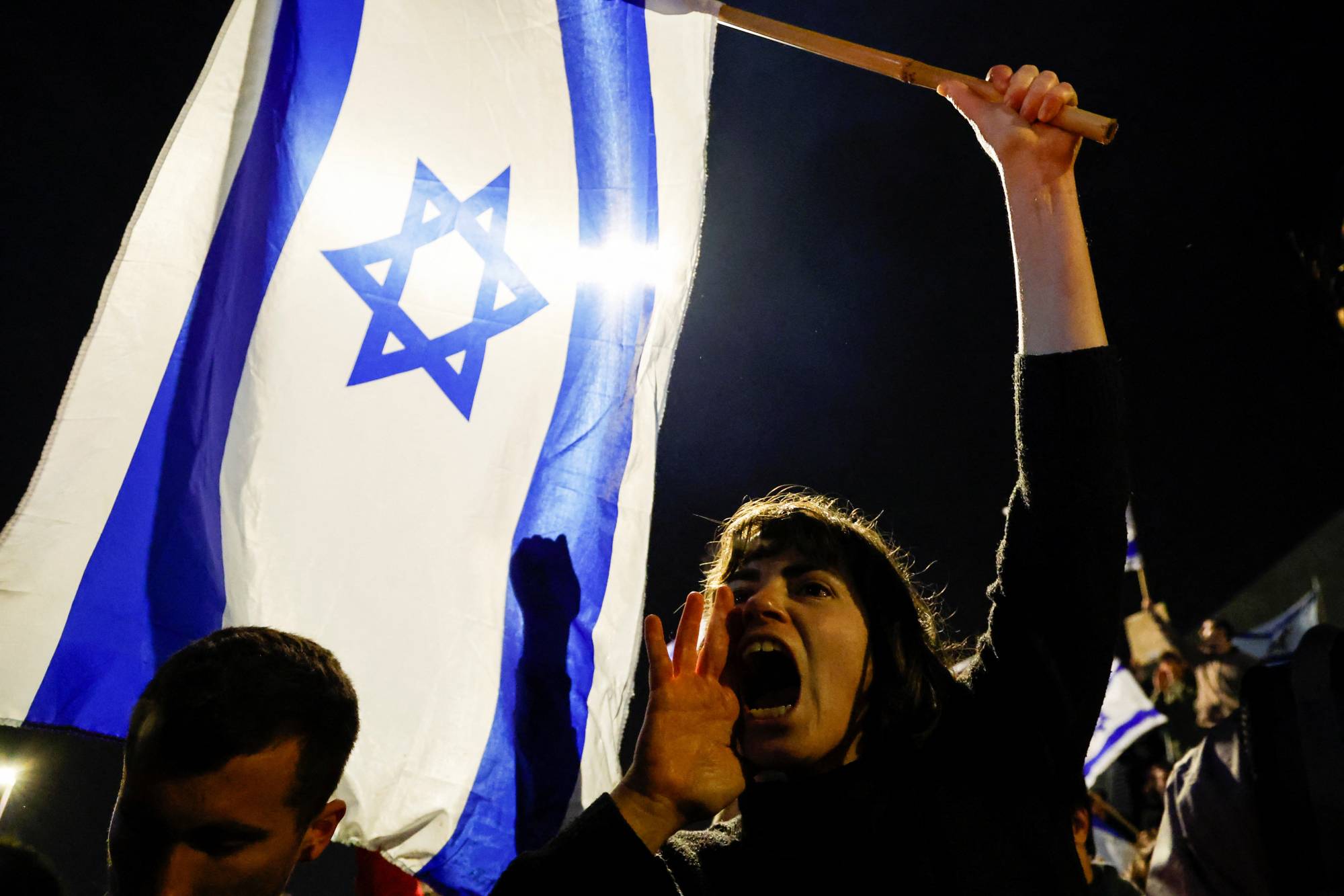 A protester at a demonstration against Israeli Prime Minister Benjamin Netanyahu's dismissal of his defense minister, in Jerusalem, on Monday | REUTERS