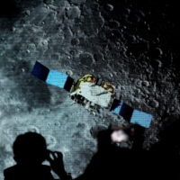 A screen shows footage of the Chang\'e-5 Mission at the National Astronomical Observatories of Chinese Academy of Sciences in Beijing in 2021. | REUTERS