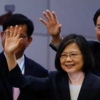 Taiwanese President Tsai Ing-wen waves to the media before her departure to New York to start her trip to Guatemala and Belize at Taoyuan International Airport in Taoyuan, Taiwan, on Wednesday. | REUTERS